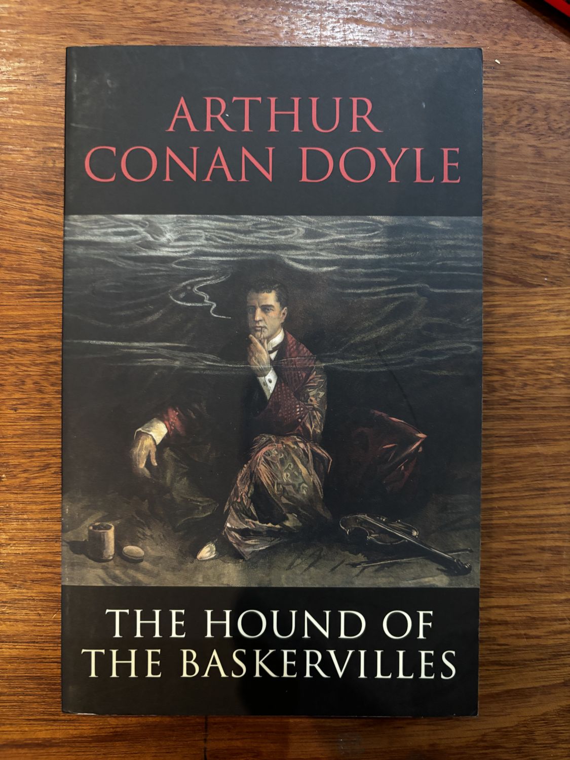The Hound of the Baskervilles — Arthur Conan Doyle (paperback, black cover)